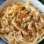 Creamy Cajun Chicken Pasta 2 Creamy Cajun chicken pasta served in a white bowl with parsley garnish and penne pasta.